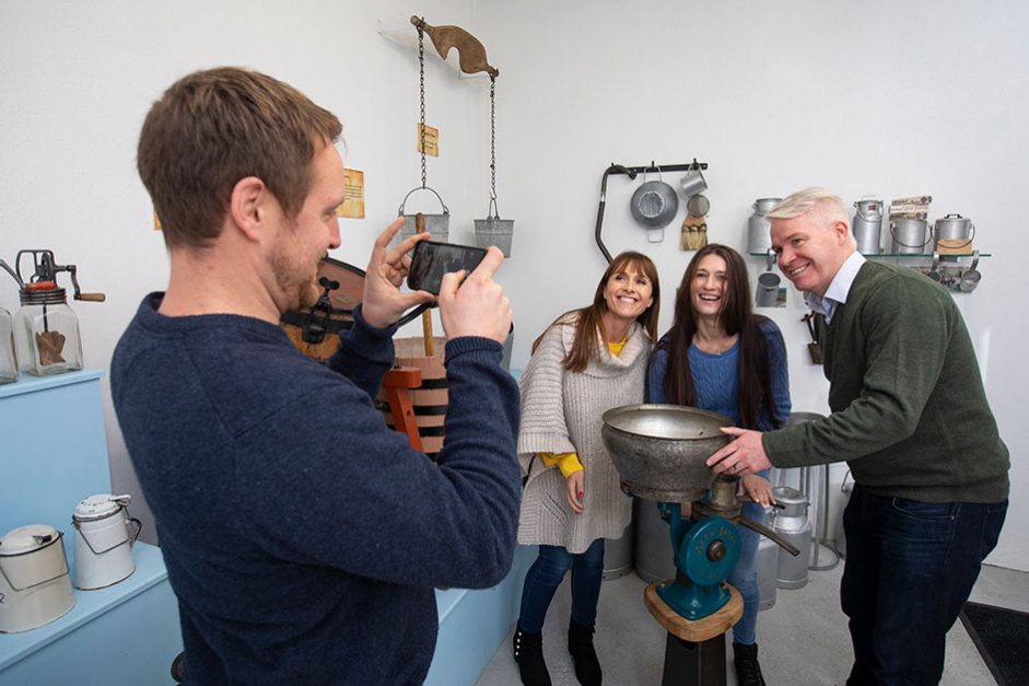 A Visitor taking a picture of his group with museum collection