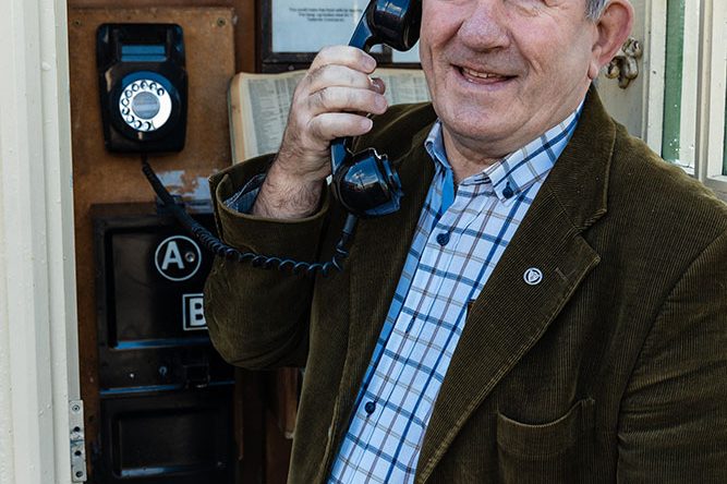 A Visitor holding Telephone